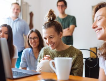 Group Of People Watching a Gray Laptop