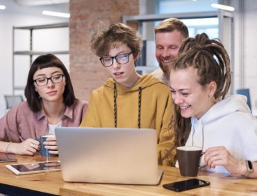 Photo of people looking on the laptop