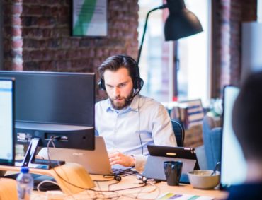 Photo Of Man In Official Shirt Sitting Looking At his Laptop